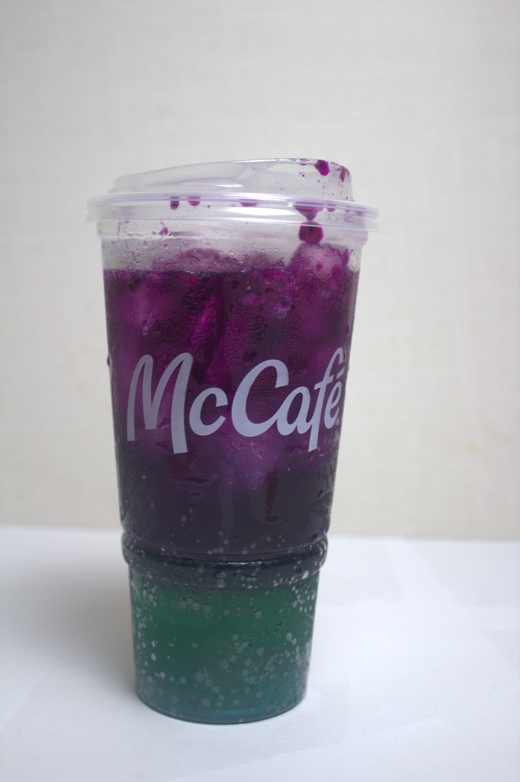 McCafé cup filled with a layered purple and teal Red Bull Dragonberry Energizer
